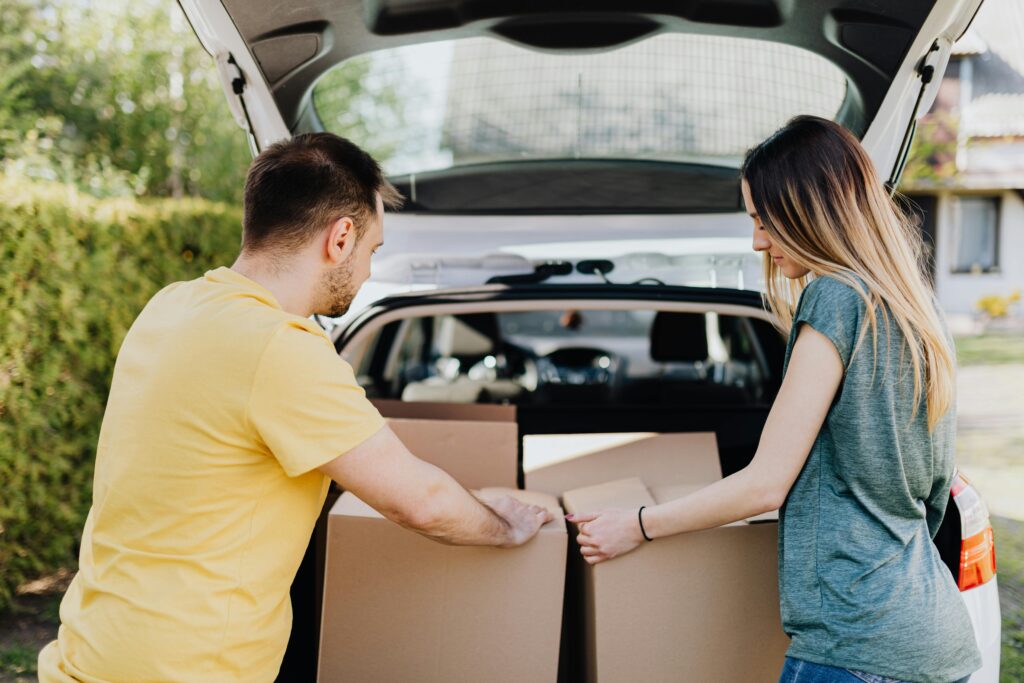 adults unloading donations from a trunk