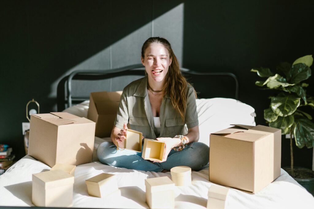woman on bed packing making a funny face